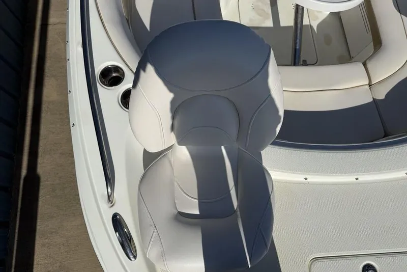 Slide: The Image of 2014 SouthWind 212sd boat interior with white seating and cup holders. - 21