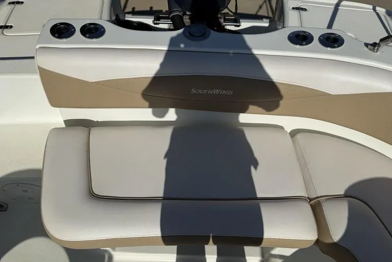 Slide: The Image of 2014 SouthWind 212sd boat interior with beige seating and cup holders. - 22
