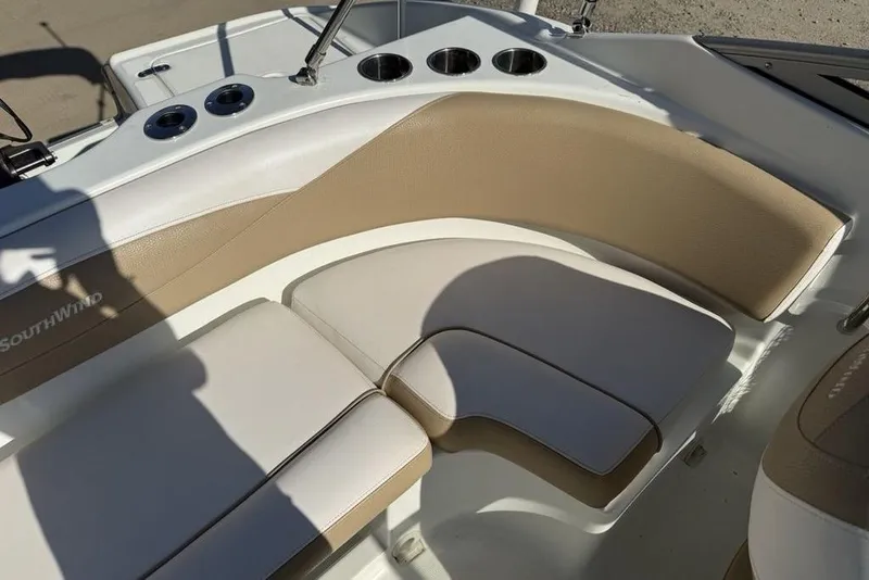 Slide: The Image of 2014 SouthWind 212sd boat interior with beige and white seating and cup holders. - 23