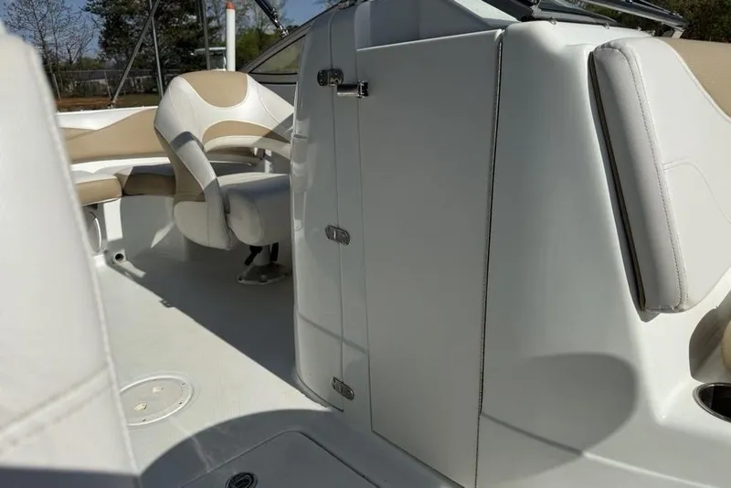 Slide: The Image of Interior view of a 2014 SouthWind 212sd boat, featuring beige and white seating. - 25