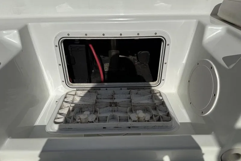 Slide: The Image of Open storage compartment on a 2014 SouthWind 212sd boat, showing interior details. - 28