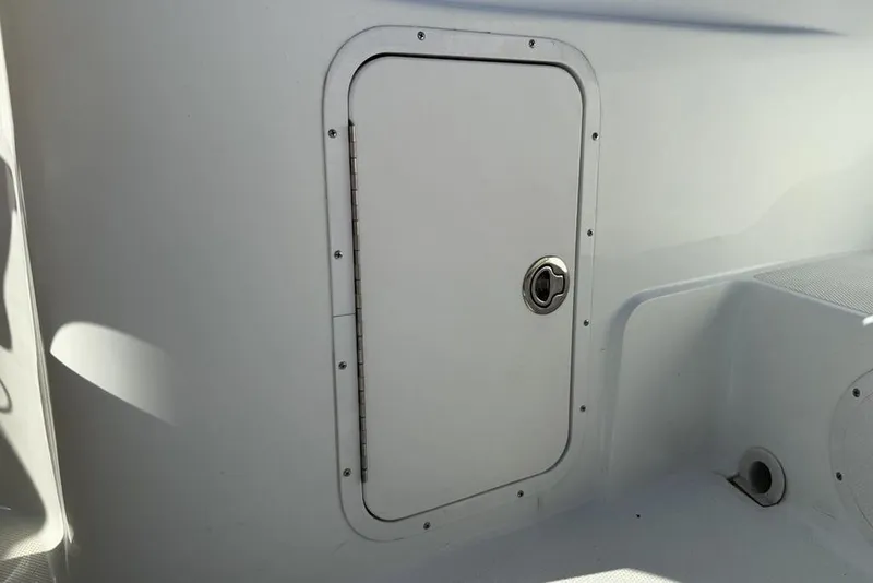 Slide: The Image of Storage compartment on a 2014 SouthWind 212sd boat, featuring a secure latch. - 35
