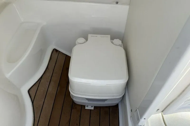 Slide: The Image of Portable toilet on 2014 SouthWind 212sd boat with wooden flooring. - 38