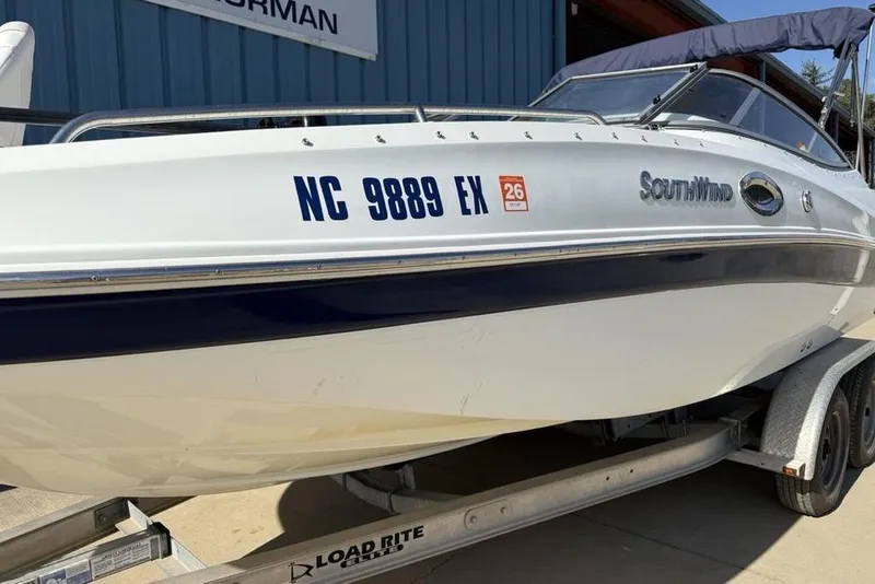 Slide: The Image of 2014 SouthWind 212sd boat on trailer, registration NC 9889 EX, parked outdoors. - 4