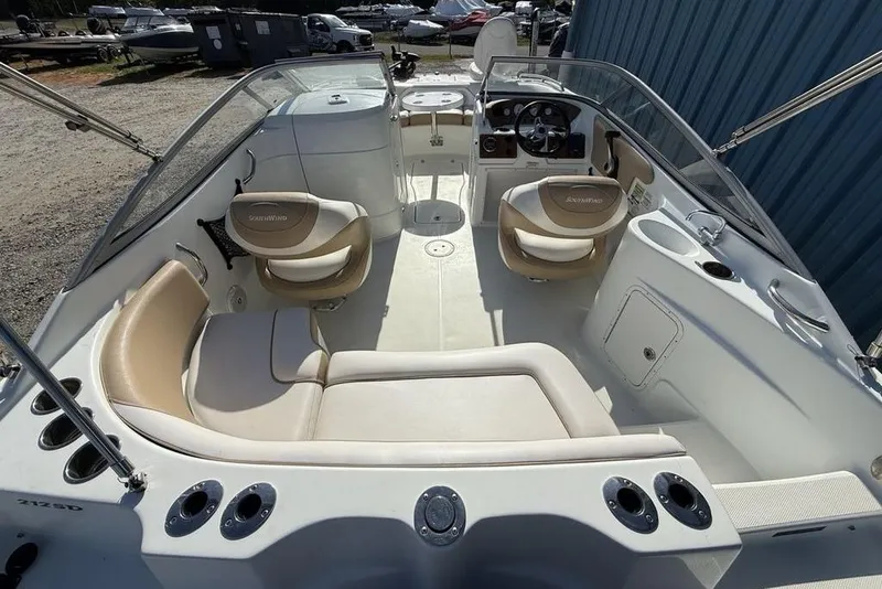 Slide: The Image of 2014 SouthWind 212sd boat interior with beige seating and steering console. - 40
