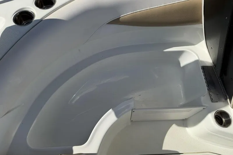 Slide: The Image of Interior view of a 2014 SouthWind 212sd boat, featuring seating and cup holders. - 42