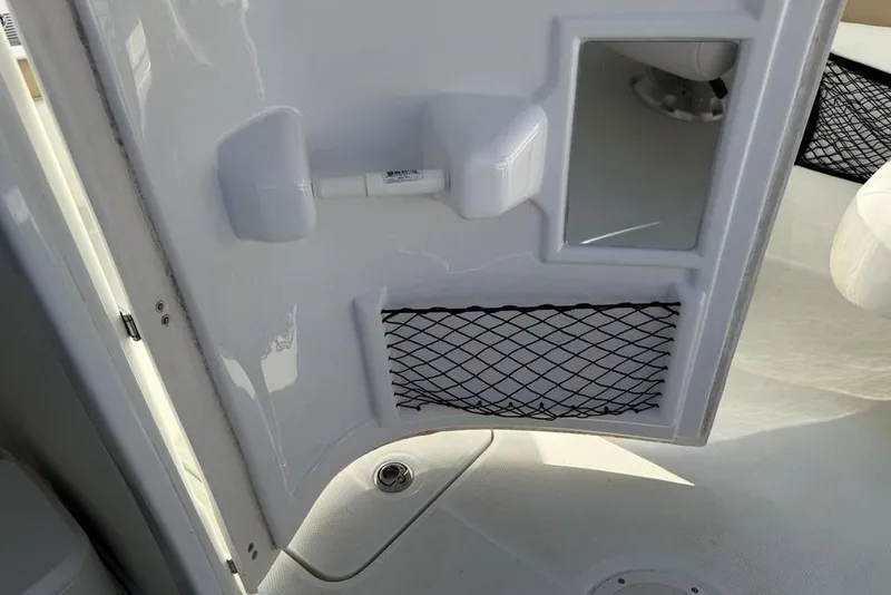 Slide: The Image of Interior view of a 2014 SouthWind 212sd boat door with storage netting. - 43