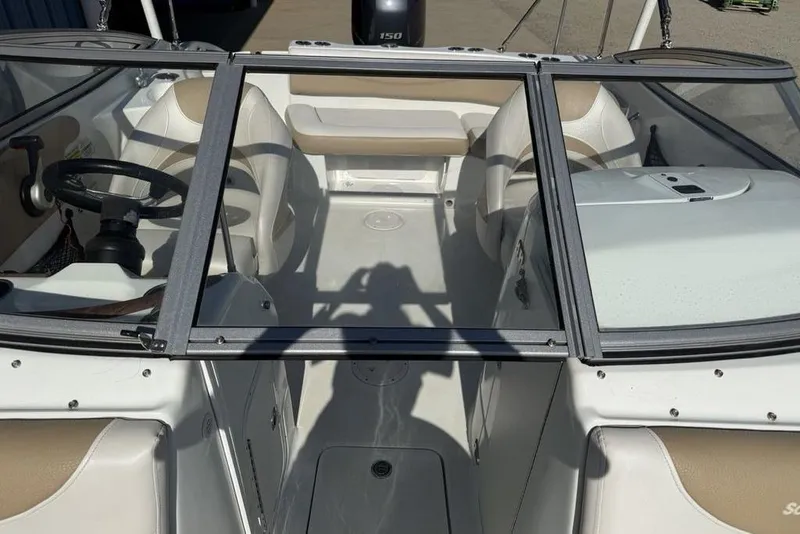 Slide: The Image of 2014 SouthWind 212sd boat interior with beige seating and steering wheel. - 44