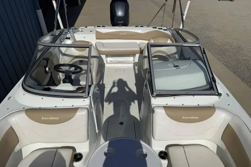 Slide: The Image of 2014 SouthWind 212sd boat interior with beige seating and dual windshields. - 46