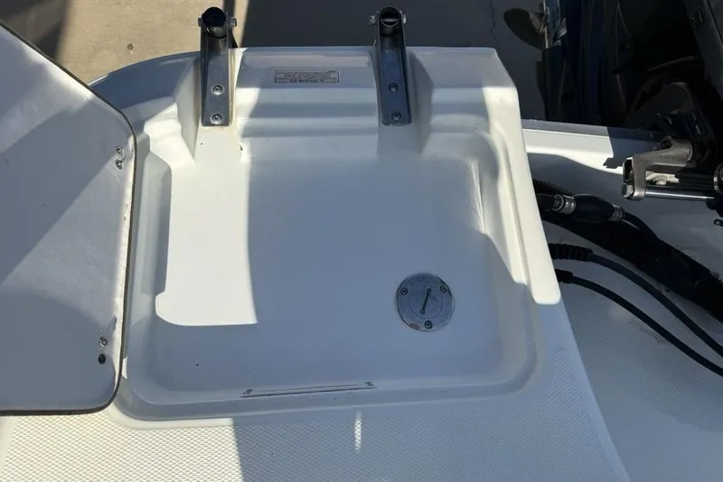 Slide: The Image of 2014 SouthWind 212sd boat deck with storage compartment and rod holders. - 49