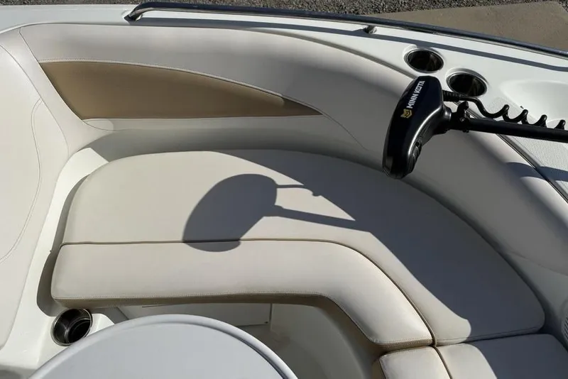 Slide: The Image of 2014 SouthWind 212sd boat interior with beige seating and cup holders. - 9