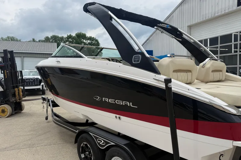 Slide: The Image of 2019 Regal LS4 boat with sleek black and red design on a trailer. - 5