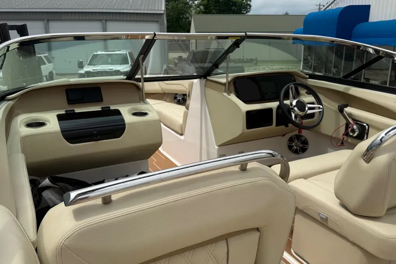 Slide: The Image of Interior of a 2019 Regal LS4 boat, featuring beige seating and modern dashboard controls. - 8