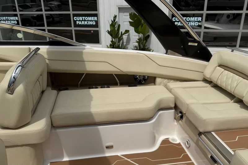 Slide: The Image of Luxurious seating on a 2019 Regal LS4 boat, featuring beige upholstery and sleek design. - 9