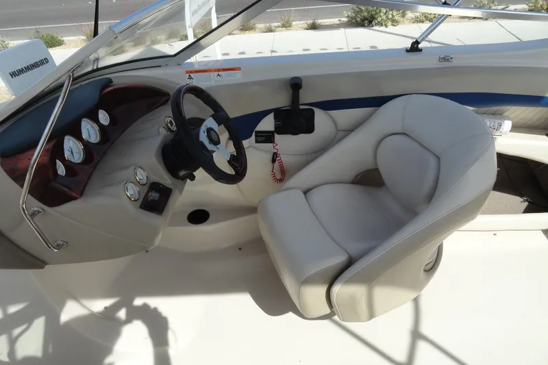 Slide: The Image of 2004 Glastron GX 205 Ski & Fish boat interior with steering wheel and gauges. - 10