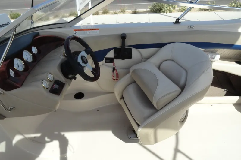 Slide: The Image of 2004 Glastron GX 205 Ski & Fish boat interior with steering wheel and gauges. - 11