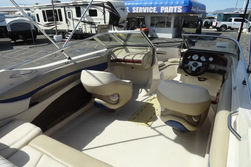 Slide: The Image of 2004 Glastron GX 205 Ski & Fish boat interior with beige seating and dashboard. - 13