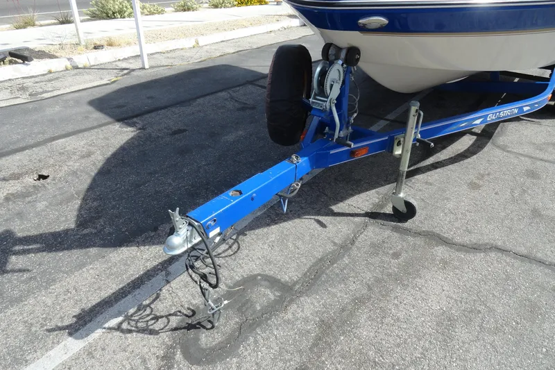 Slide: The Image of 2004 Glastron GX 205 Ski & Fish boat trailer on asphalt. - 25