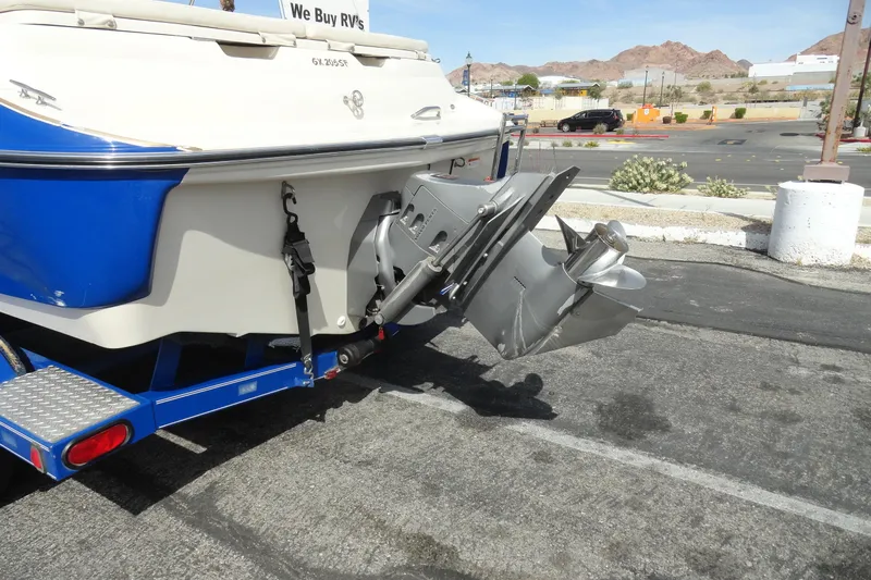 Slide: The Image of 2004 Glastron GX 205 Ski & Fish boat rear view with outboard motor in parking lot. - 27