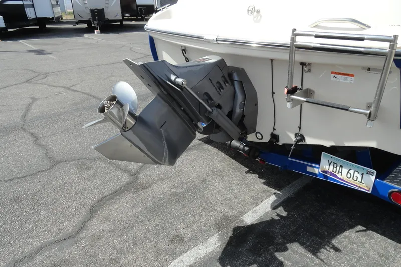 Slide: The Image of 2004 Glastron GX 205 Ski & Fish boat with outboard motor and trailer in parking lot. - 28