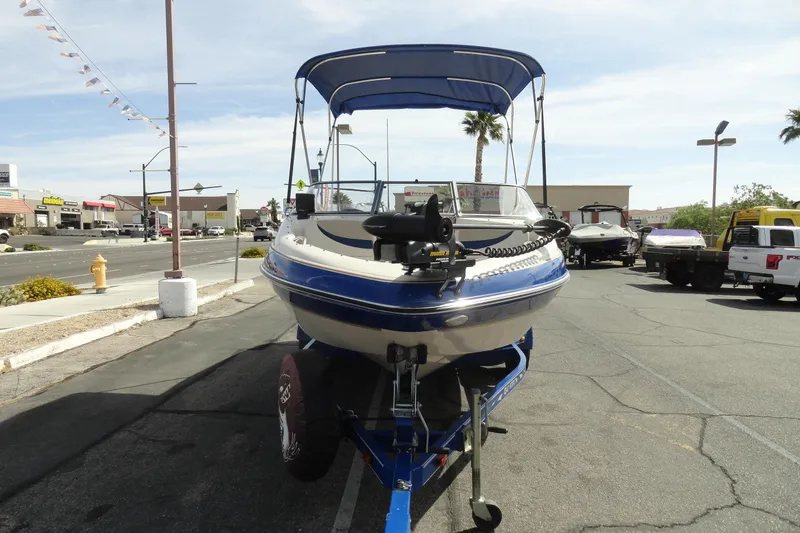 Slide: The Image of 2004 Glastron GX 205 Ski & Fish boat on trailer in parking lot. - 3