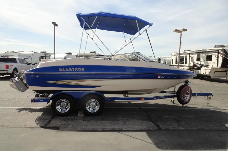 Slide: The Image of 2004 Glastron GX 205 Ski & Fish boat with blue canopy on trailer. - 5