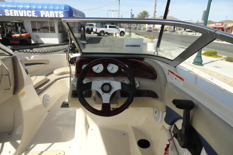 Slide: The Image of 2004 Glastron GX 205 Ski & Fish boat dashboard with steering wheel and gauges. - 8