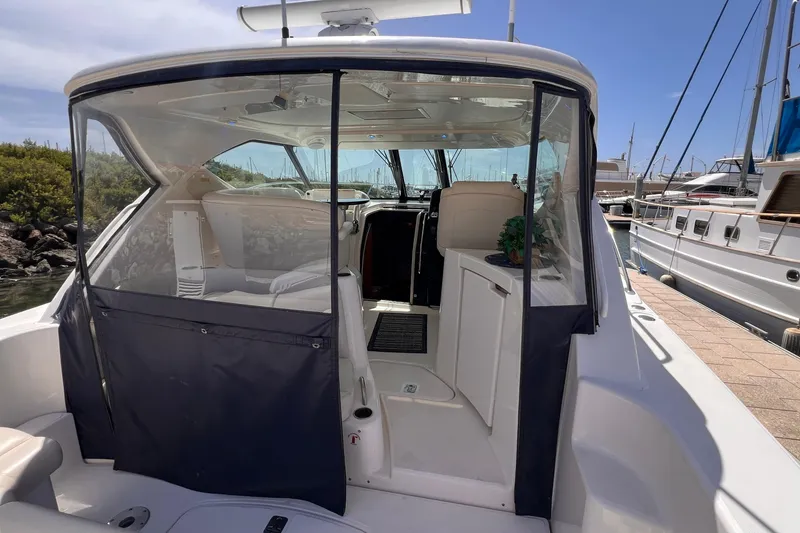 Slide: The Image of 2008 Tiara Yachts 3500 Sovran docked, showcasing cockpit and interior seating area. - 11