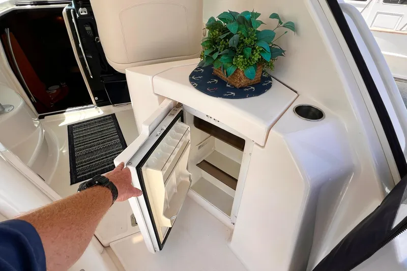 Slide: The Image of 2008 Tiara Yachts 3500 Sovran interior with open fridge and decorative plant. - 13