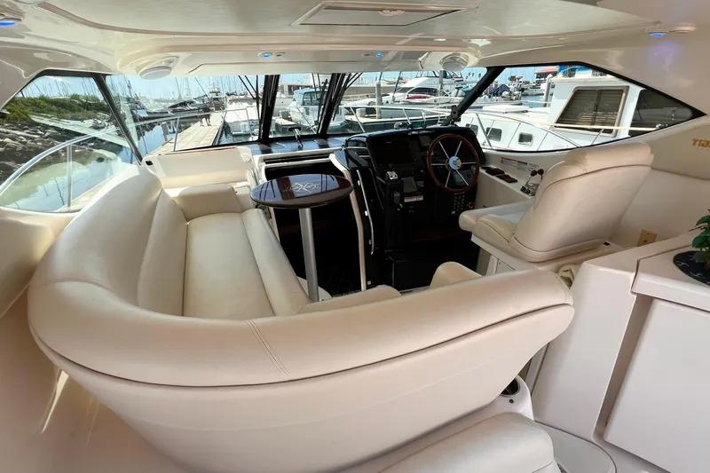 Slide: The Image of Luxurious interior of a 2008 Tiara Yachts 3500 Sovran, featuring plush seating and helm. - 15