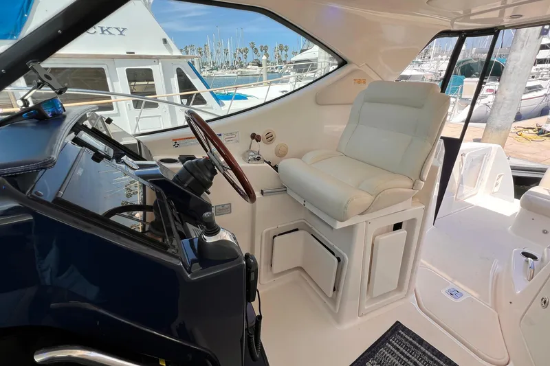 Slide: The Image of 2008 Tiara Yachts 3500 Sovran helm with white captain's chair and marina view. - 22