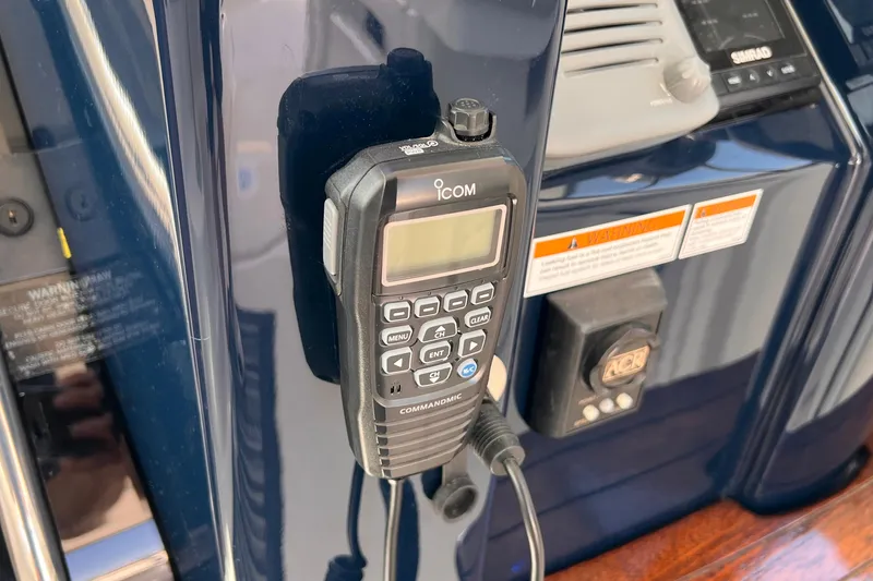 Slide: The Image of ICOM radio on 2008 Tiara Yachts 3500 Sovran dashboard, featuring control panel and warning labels. - 29