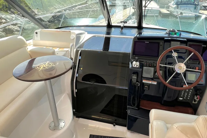 Slide: The Image of Interior view of 2008 Tiara Yachts 3500 Sovran helm with steering wheel and seating area. - 32