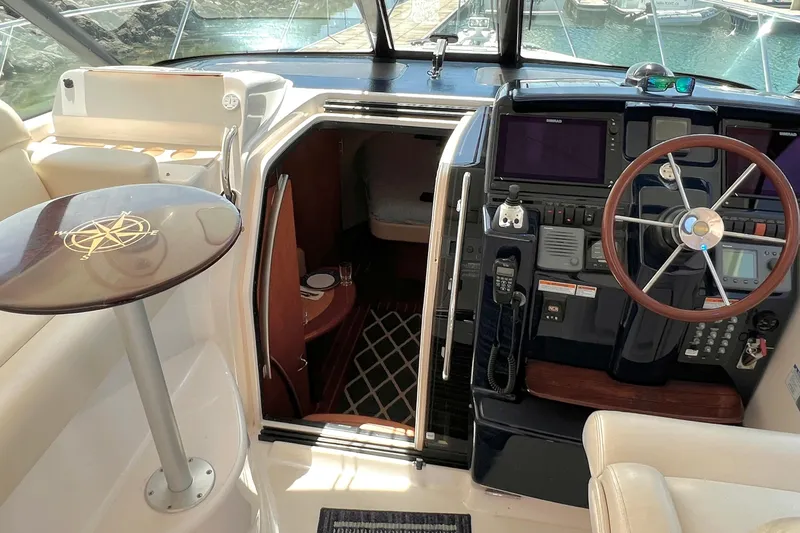 Slide: The Image of 2008 Tiara Yachts 3500 Sovran cockpit with steering wheel and cabin entrance. - 33