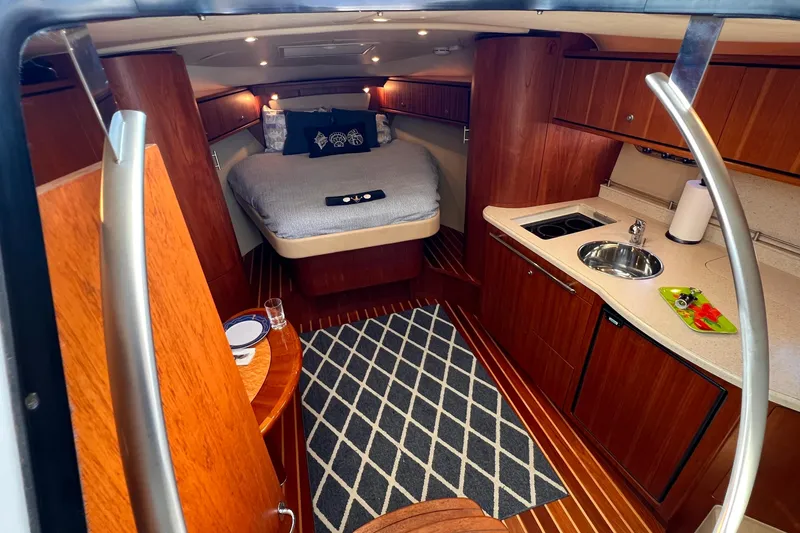 Slide: The Image of Luxurious 2008 Tiara Yachts 3500 Sovran interior with cozy bed and modern kitchenette. - 34