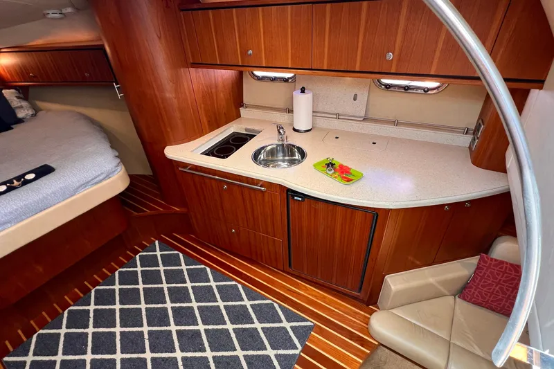 Slide: The Image of Interior of 2008 Tiara Yachts 3500 Sovran with kitchen and sleeping area. - 35