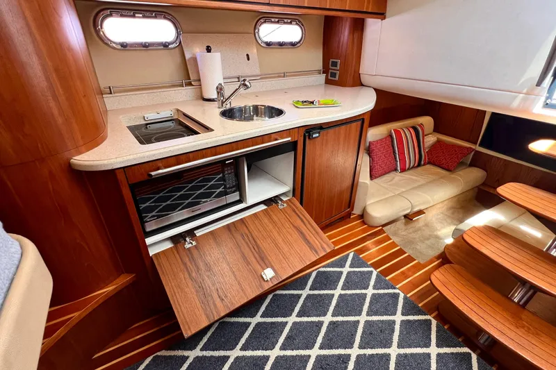 Slide: The Image of 2008 Tiara Yachts 3500 Sovran interior with kitchenette, sink, and cozy seating area. - 39