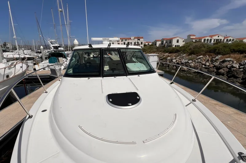 Slide: The Image of 2008 Tiara Yachts 3500 Sovran docked at marina, clear sky, residential backdrop. - 4