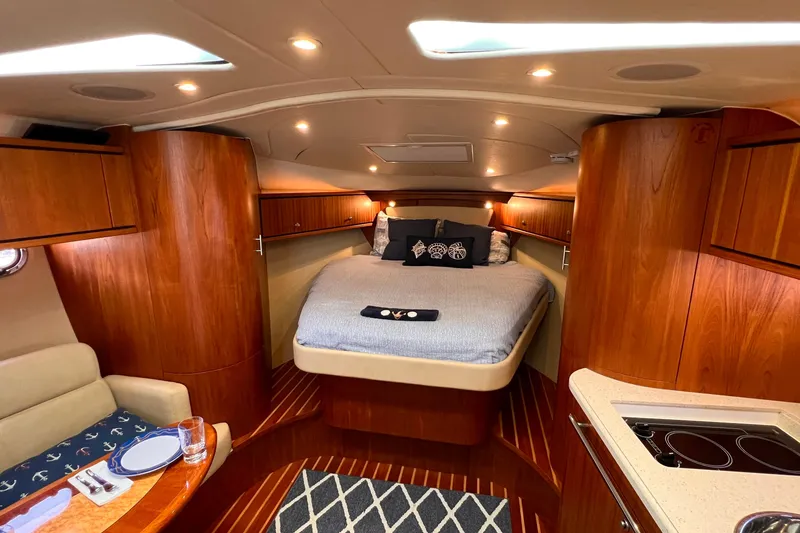 Slide: The Image of Luxurious 2008 Tiara Yachts 3500 Sovran cabin interior with cozy bed and elegant wood finish. - 42