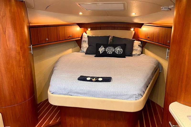 Slide: The Image of Luxurious cabin interior of 2008 Tiara Yachts 3500 Sovran with cozy bedding and wooden accents. - 43