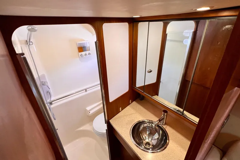 Slide: The Image of Luxurious bathroom in 2008 Tiara Yachts 3500 Sovran with modern fixtures and wood accents. - 48