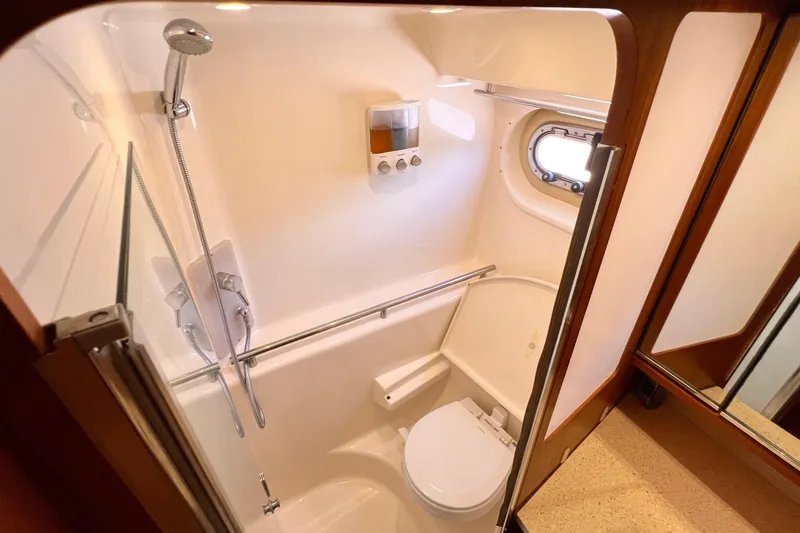 Slide: The Image of Bathroom interior of 2008 Tiara Yachts 3500 Sovran with shower and porthole window. - 49