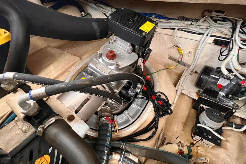 Slide: The Image of Engine compartment of a 2008 Tiara Yachts 3500 Sovran, showcasing mechanical components and wiring. - 54