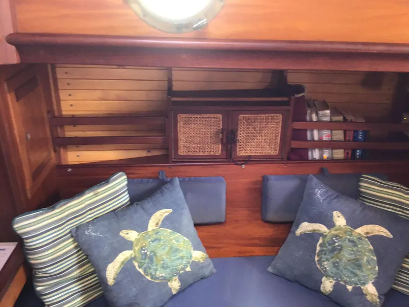 Slide: The Image of Interior of a 2006 Bristol Channel Cutter 28 with nautical-themed pillows. - 29