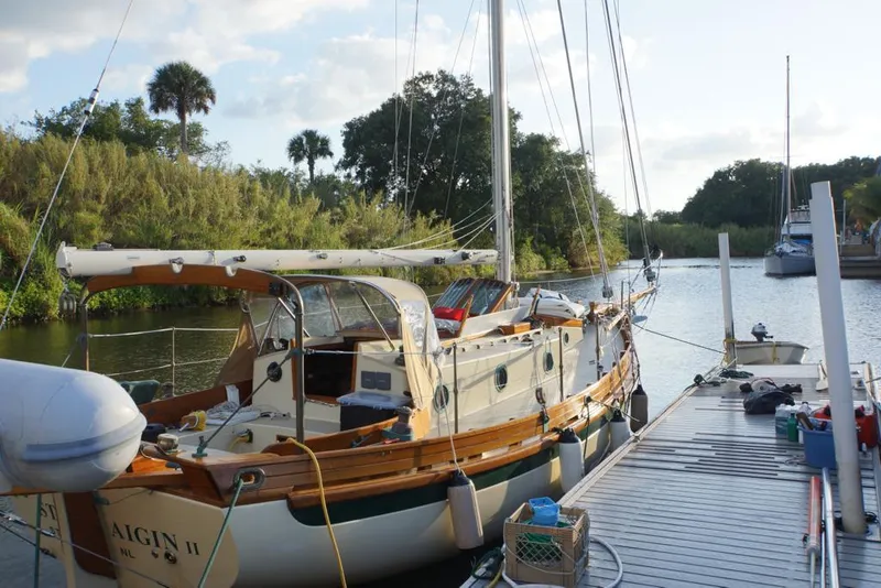 Slide: The Image of 2006 Bristol Channel Cutter 28 sailboat docked by the water. - 3