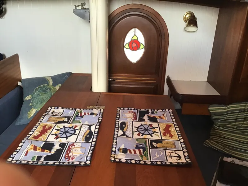 Slide: The Image of Interior of a 2006 Bristol Channel Cutter 28 with nautical-themed placemats. - 30