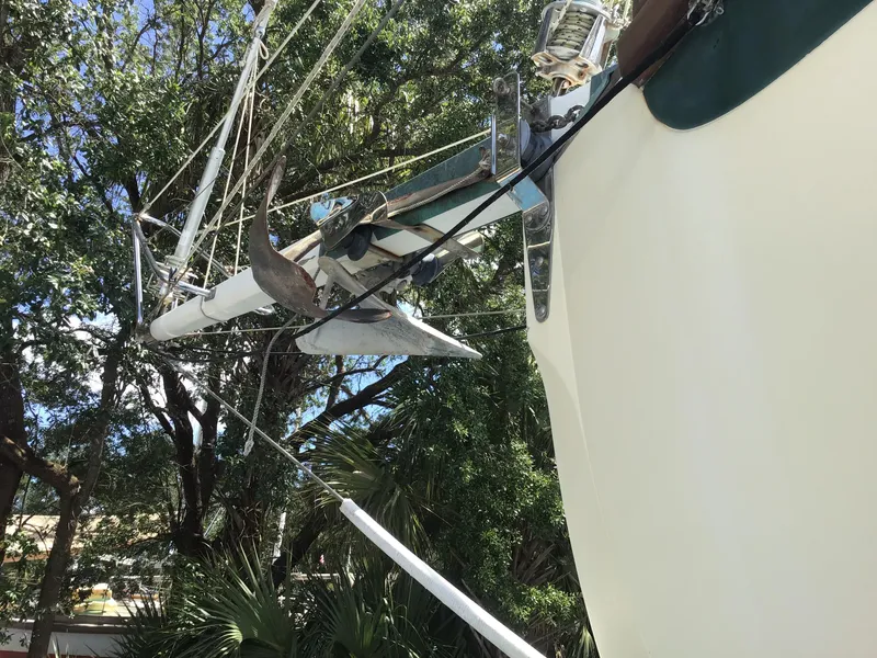 Slide: The Image of Bristol Channel Cutter 28 sailboat bow view, 2006 model, against trees. - 34