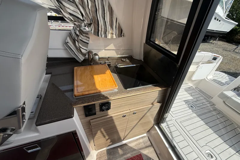 Slide: The Image of 2024 Solara S-250 Coupe interior kitchenette with sink, cutting board, and modern design. - 12