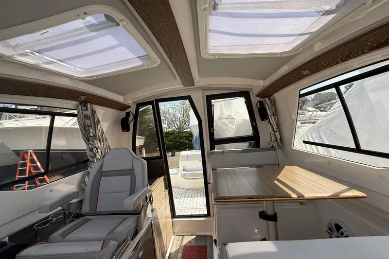 Slide: The Image of Interior of 2024 Solara S-250 Coupe boat with seating and table, showcasing modern design. - 19