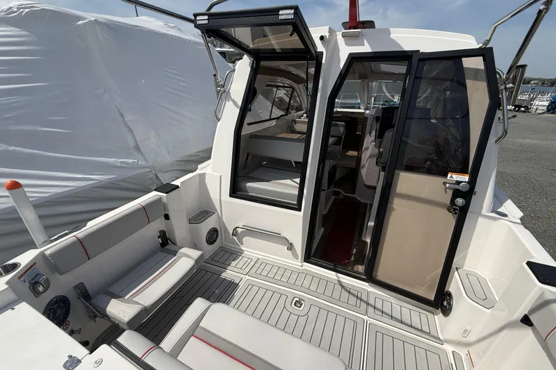 Slide: The Image of 2024 Solara S-250 Coupe boat interior with open doors and seating area. - 20